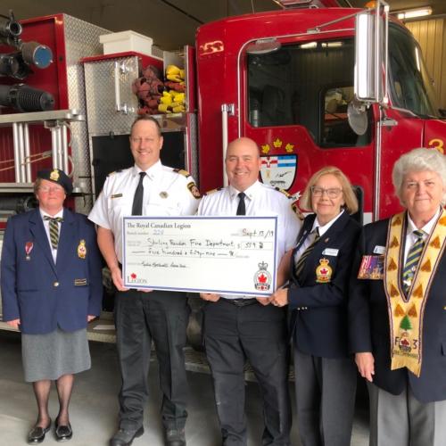 Fire Chief Derrick Little and Deputy Fire Chief Bruce Farquhar accept a cheque from the Royal Canadi